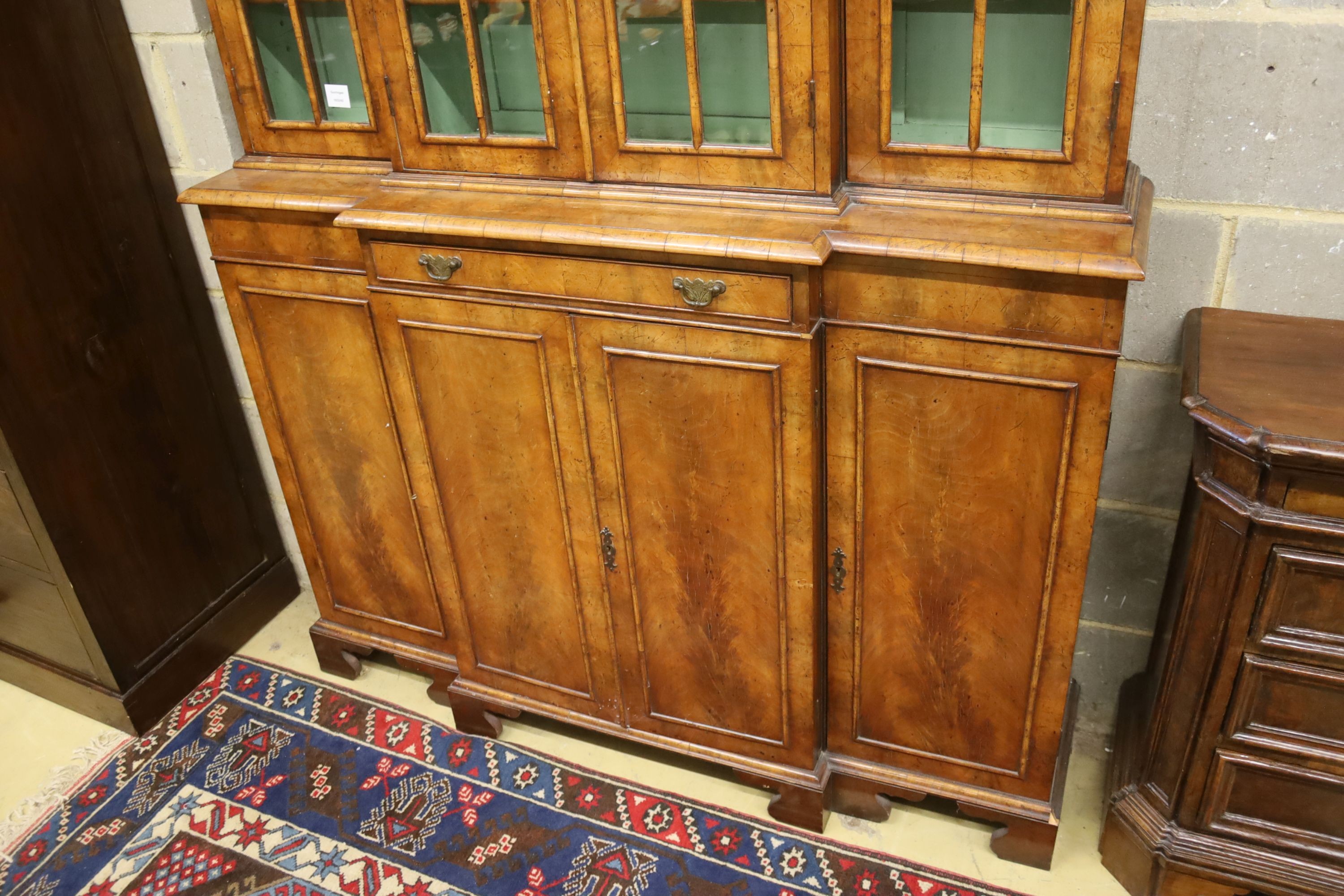 A small Queen Anne revival walnut breakfront library bookcase, length 132cm, depth 34cm, height 190cm